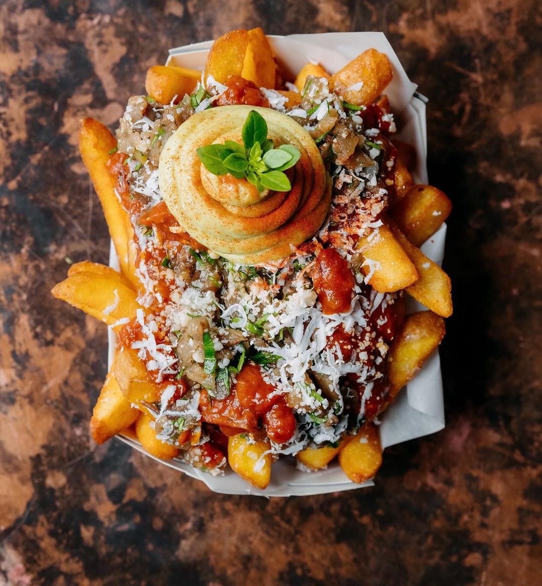 Veggie Tomato Pronto Fries topped with tender eggplant, aromatic garlic & basil mayonnaise 