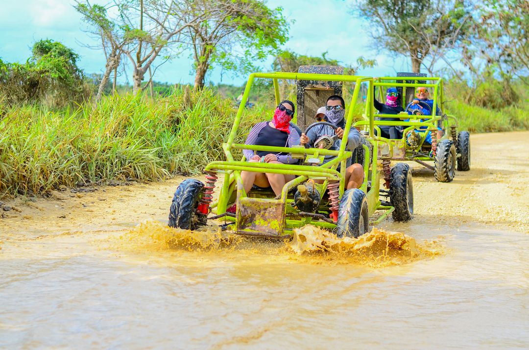 {FAMILY BUGGY FOR 3-4 }  Get ready for a wild ride! You'll drive your own buggy through muddy trails, explore a hidden cave, visit a traditional Dominican house for local tastings (like coffee, cacao & mamajuana), and finish off with a swim at the stunning Macao Beach. Adventure, culture, and fun—all in one tour!