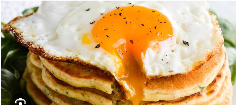 Pancakes with sunny sideup eggs, sausage & tomato