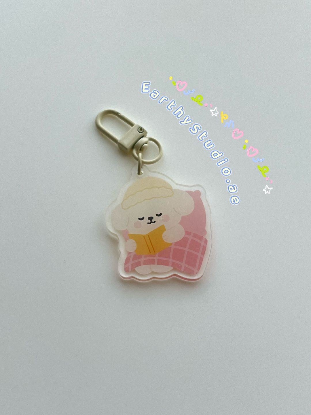 Poppy reading book keychain 