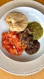 Kenkey with red pepper, green pepper and shito