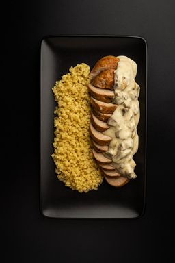 Карбонат из запеченной свиной вырезки под грибным соусом с булгуром