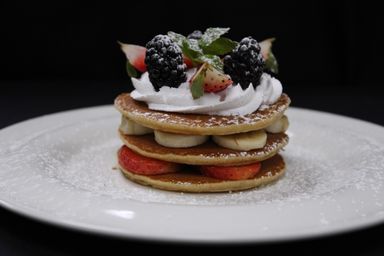 Pancakes with Strawberries, Bananas & Topped with Whipped Cream