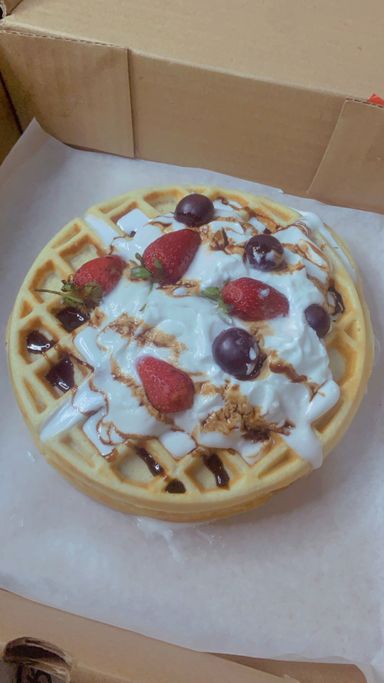 Waffles whipped cream and mixed fruit 