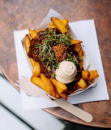 Pulled Beef Brisket with Classic Mayonnaise & Pickled Mustard Seeds on top of Crispy Fries 