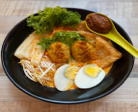 Laska served with egg, prawn wanton, fish cake, tau pok and choice of noodles